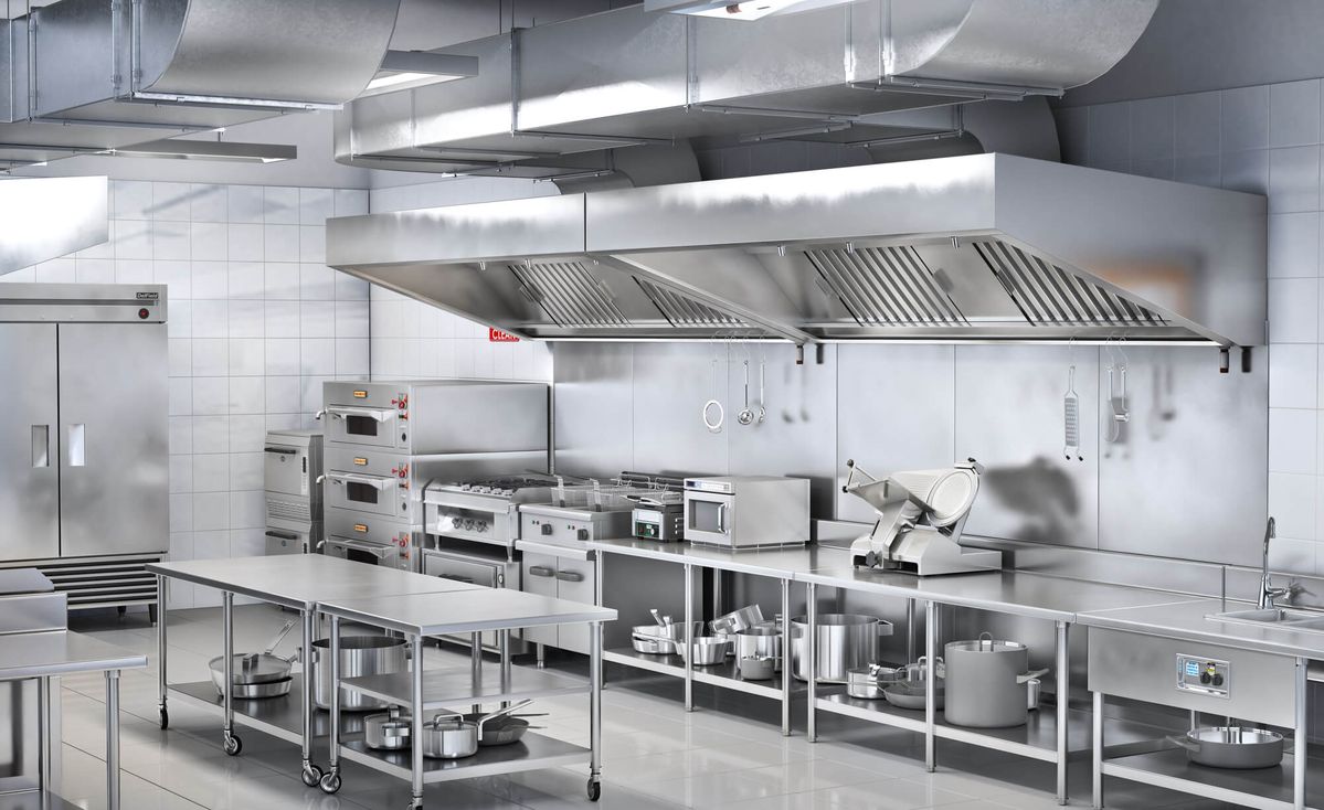 Fitted commercial kitchen with stainless steel canopy, prep tables and cooking line