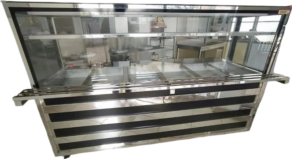 Layaan bain marie servery counter with heated wells under a glazed case, a tray slide along the customer face and a mirror and black banded base