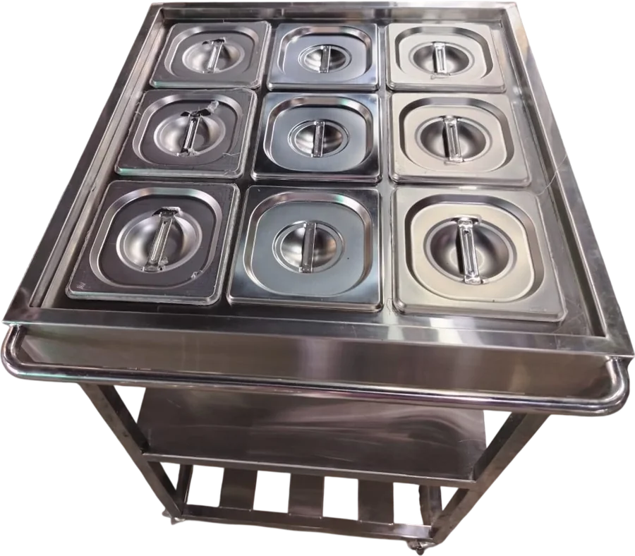 Layaan nine-pan gastronorm trolley with lidded pans in a three by three top, a push rail, a solid shelf and a slatted rack beneath, on castors