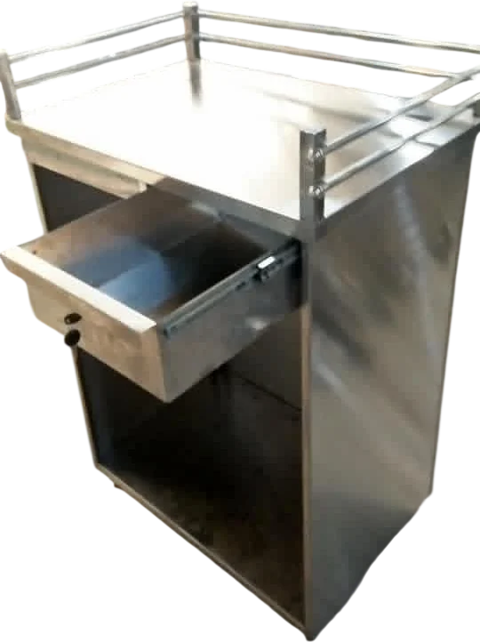 Layaan stainless steel service counter with a tubular gallery rail, its drawer pulled open and an open compartment below