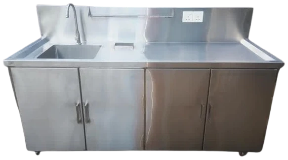 Layaan stainless steel sink cabinet unit seen from the front, with a bowl and tap at one end and four cupboard doors below