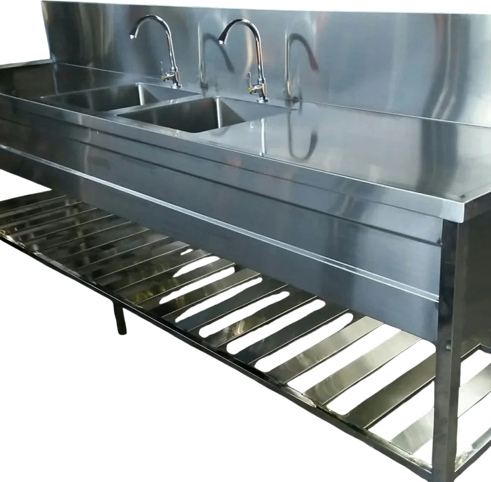 Layaan twin bowl stainless steel sink with two deep bowls side by side, a swan-neck pillar tap over each, a full-length rear splashback and a slatted undershelf