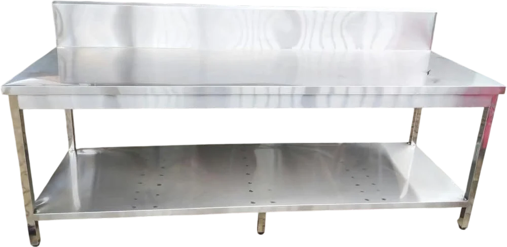 Layaan long stainless steel work table seen square on, with a raised rear splashback, a full-length solid undershelf and a centre leg under the run