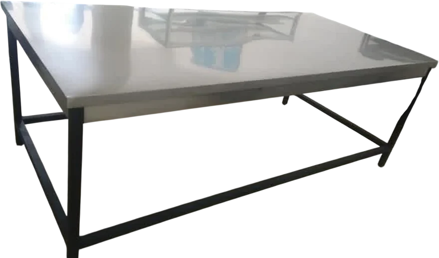 Layaan work table with a wide stainless steel top on a black painted steel frame braced with cross rails