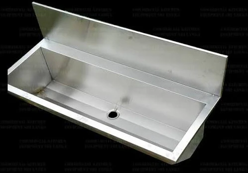 Layaan wall-hung stainless steel hand wash trough with an integral rear splashback and a centre waste outlet